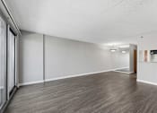 Thumbnail 94 of 151 - A room with wooden flooring and white walls.