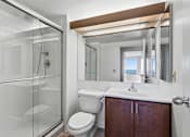 Thumbnail 104 of 151 - A white toilet sits next to a sink in a bathroom.