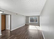 Thumbnail 118 of 151 - A room with a wooden floor and a window with a view of a city.