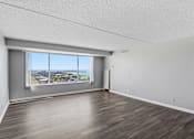 Thumbnail 151 of 151 - A room with a large window overlooking a cityscape.