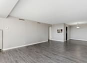 Thumbnail 112 of 151 - A spacious room with grey flooring and white walls.