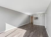 Thumbnail 115 of 151 - A room with a wooden floor and white walls.