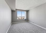 Thumbnail 123 of 151 - A room with a large window overlooking a cityscape.