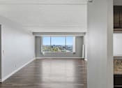 Thumbnail 148 of 151 - A room with a large window overlooking a cityscape.