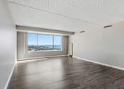 Thumbnail 106 of 151 - A room with a large window overlooking a cityscape.