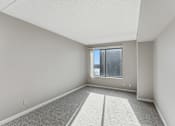 Thumbnail 121 of 151 - A room with a carpeted floor and a window.