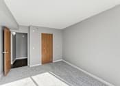 Thumbnail 116 of 151 - A room with a carpeted floor and two doors.