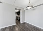 Thumbnail 134 of 151 - A room with a wooden floor and a light hanging from the ceiling.