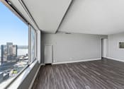 Thumbnail 145 of 151 - A room with a large window overlooking a cityscape.