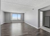 Thumbnail 136 of 151 - A spacious room with wooden flooring and a large window.