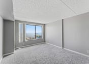 Thumbnail 143 of 151 - A room with a large window and a view of the city.