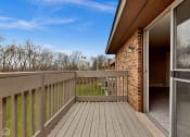 Thumbnail 30 of 38 - the deck of a home with a view of the yard and the sky