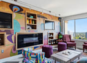 Thumbnail 45 of 151 - A living room with a colorful mural on the wall and a chess board on the coffee table.