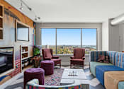 Thumbnail 51 of 151 - A living room with a large window overlooking a cityscape.