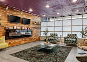 Thumbnail 49 of 151 - A living room with a fireplace and a glass coffee table.