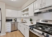 Thumbnail 3 of 38 - a kitchen with stainless steel appliances and white cabinets