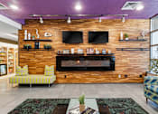 Thumbnail 50 of 151 - A living room with a fireplace and a flat screen TV mounted on the wall.