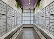 Thumbnail 89 of 151 - A long hallway with mailboxes on both sides.