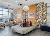 Thumbnail 85 of 151 - A living room with a sofa, chairs, and a large floral wallpaper.