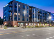 Thumbnail 79 of 82 - a large building with a street in front of it at night