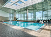 Thumbnail 82 of 151 - A large indoor swimming pool with a skylight above it.