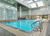 Thumbnail 77 of 151 - A large indoor swimming pool with a glass wall on one side.