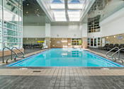 Thumbnail 76 of 151 - A large indoor swimming pool with a glass ceiling.