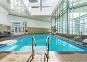 Thumbnail 72 of 151 - A large indoor swimming pool with a glass ceiling.