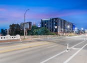 Thumbnail 81 of 82 - an empty city street at night with a building in the background