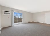 Thumbnail 6 of 38 - an empty living room with a door to a balcony