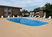 Thumbnail 24 of 29 - A swimming pool surrounded by sun loungers and apartment buildings.