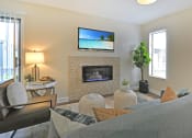 Thumbnail 5 of 32 - a living room with a fireplace and a tv above it
