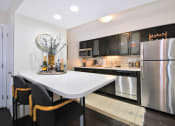 Thumbnail 1 of 32 - a kitchen with stainless steel appliances and a white countertop island