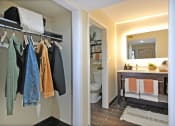 Thumbnail 6 of 32 - a view of a bathroom and a closet with towels and a sink and a toilet