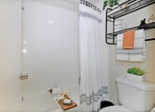 Thumbnail 7 of 32 - a bathroom with a shower and a toilet and a shower curtain