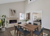 Thumbnail 8 of 32 - a dining room with a table and chairs and a fireplace