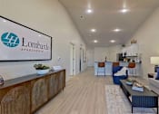 Thumbnail 9 of 12 - A spacious living room with light wood-style flooring and recessed lights in a vaulted ceiling.