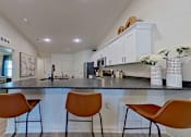 Thumbnail 5 of 12 - Stools against the kitchen breakfast bar with gooseneck sink.