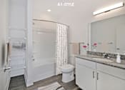 Thumbnail 6 of 46 - A white bathroom with a toilet, sink, and shower.