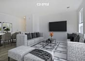 Thumbnail 7 of 46 - A living room with a grey couch and a black television.