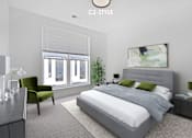 Thumbnail 11 of 46 - A modern bedroom with a large bed and a green chair.