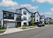 Thumbnail 5 of 59 - A row of modern townhouses with a car parked on the street.