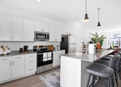 Thumbnail 13 of 46 - a kitchen with white cabinets and a counter top