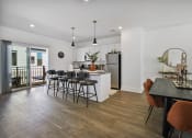 Thumbnail 16 of 46 - a kitchen and dining room with a table and chairs