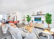 Thumbnail 20 of 46 - a living room with a couch and a table