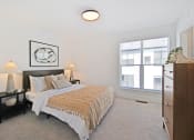 Thumbnail 21 of 46 - a bedroom with a bed and a large window