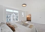 Thumbnail 24 of 46 - a bedroom with a large bed and a large window