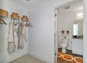 Thumbnail 25 of 46 - a bathroom with a toilet and a closet with towels