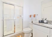 Thumbnail 26 of 46 - a bathroom with a shower and a toilet and a sink