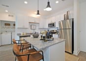 Thumbnail 30 of 46 - a kitchen with stainless steel appliances and a granite counter top